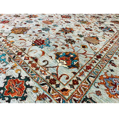 Close-up of a carpet surface with a delicate ornamental and floral pattern in light blue