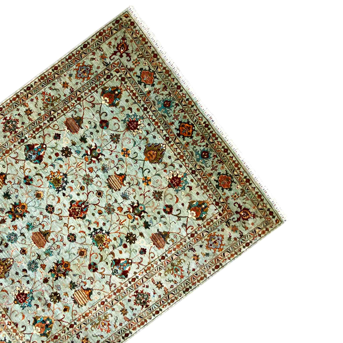 Corner of the carpet with a border frieze and light blue ornamental pattern