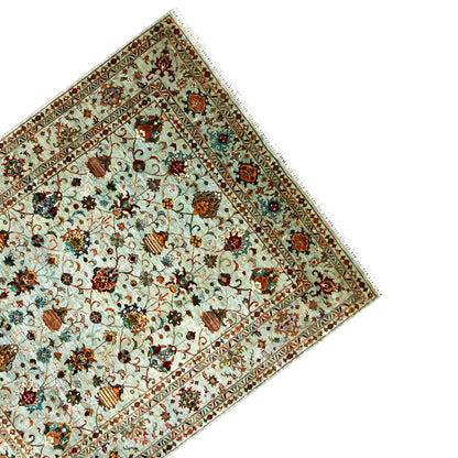 Corner of the carpet with a border frieze and light blue ornamental pattern
