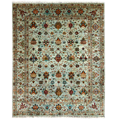 Rug with an ornamental floral pattern, light blue base color, and multicolored border