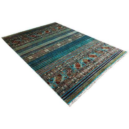 Rug in diagonal view: geometric ornaments, turquoise-blue stripes, fringe