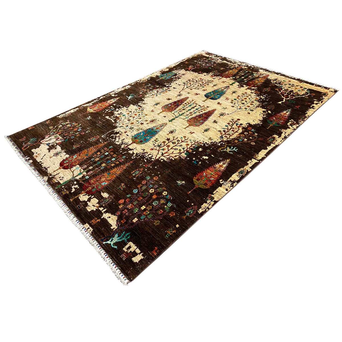 Rug viewed from an angle: cream-colored background, dark brown with colorful ornaments and fringes