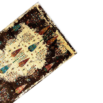 Rug corner at an angle: cream-colored center with colorful tree and animal motifs, dark brown