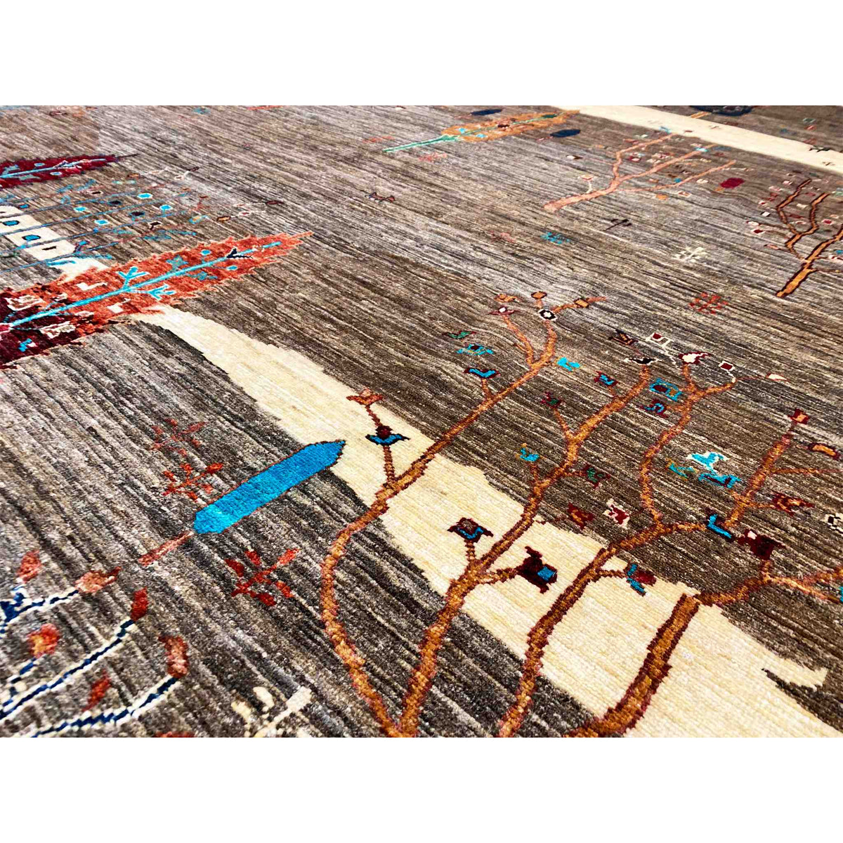 Close-up of a carpet pattern with colorful lines, ornamental areas, and a brown background