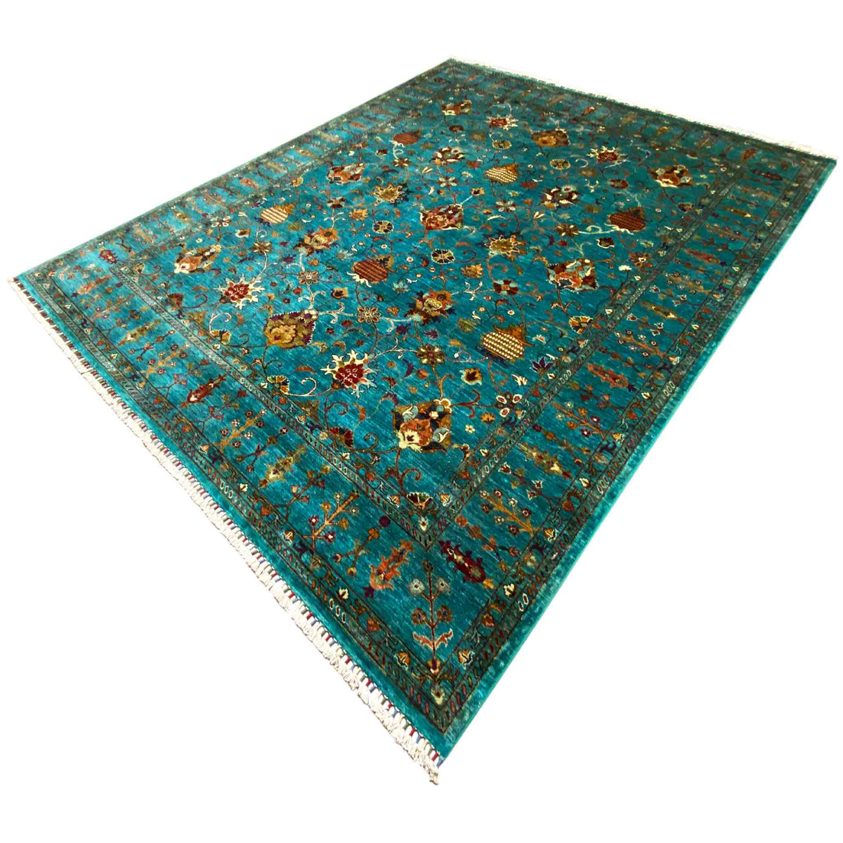 Turquoise rectangular rug with a multicolored ornamental pattern and visible fringes