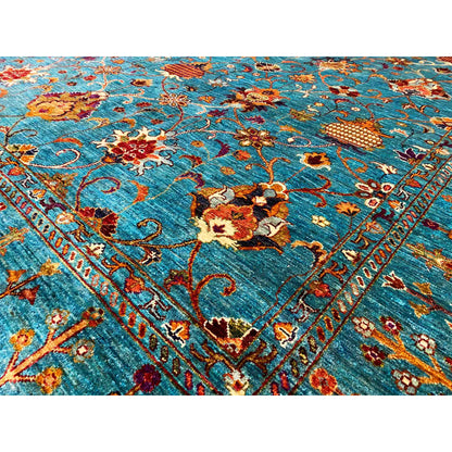 Close-up of carpet: dense floral and ornamental pattern in turquoise, red, and gold
