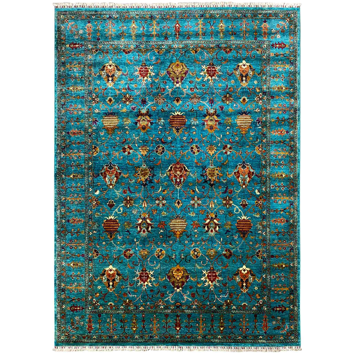 Rectangular rug with an ornamental pattern in turquoise, gold, and red, with fringes