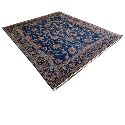 Blue rug with a floral ornamental pattern, decorative border, and square medallion