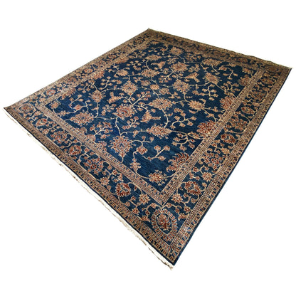 Blue Ziegler rug with golden floral vines, corner ornaments, and a bordered pattern