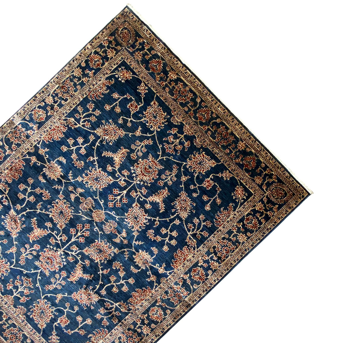 Ziegler carpet in corner view: blue base design with a gold floral vine and border