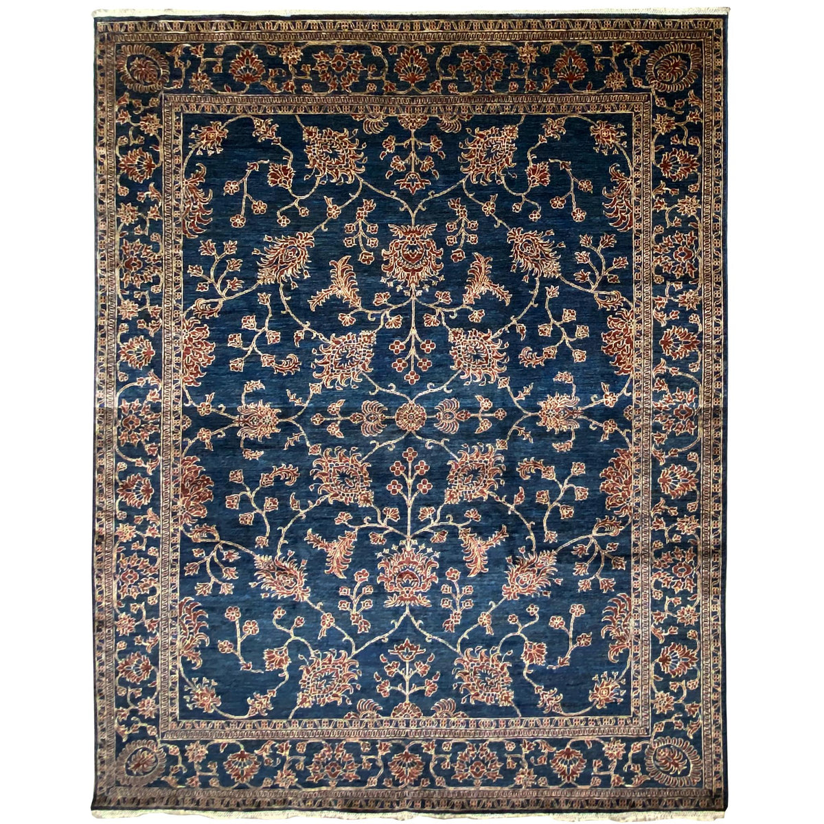 Blue Ziegler rug with gold-colored vines, a wide decorative border, and an oriental pattern