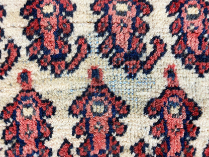 Close-up of the ornamental panels: cream background with red and blue decorative shapes