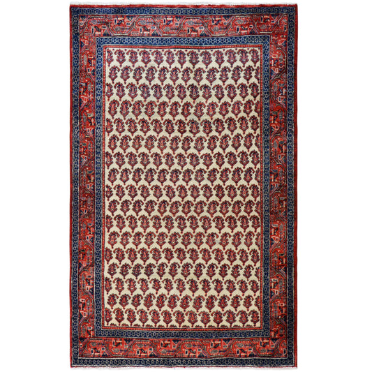 Wool rug with an oriental border pattern in red, dark blue and cream