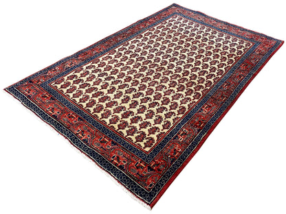 Rectangular rug with a small medallion pattern in cream, red, and dark blue