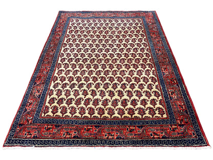 Rug with a rug border and patterned frieze; cream background with red and blue accents