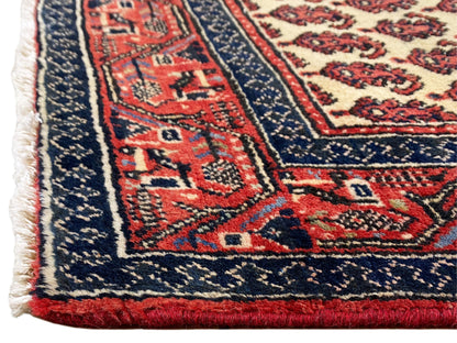 Detailed view: dark blue and red carpet border with decorative ornaments