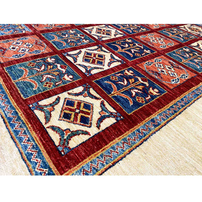 Close-up of the carpet pattern: blue and red tiles with delicate cream-colored ornaments