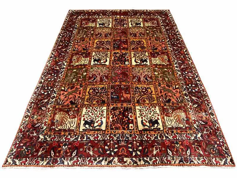 Oriental rug in a quatrefoil design with repeating motifs in red, cream, and dark brown