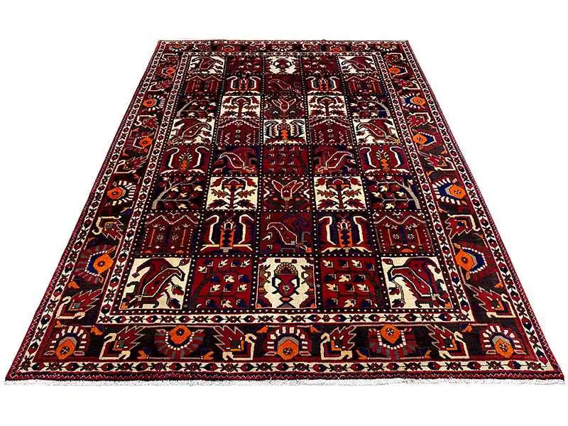 Bakhtiari rug front view: burgundy-red pattern with a central field and surrounding border