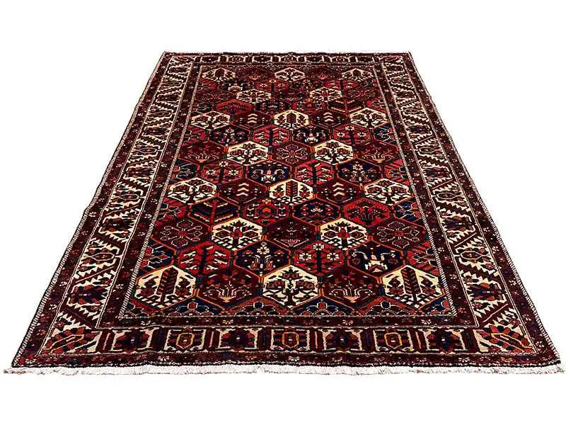 Rectangular Persian rug with an orderly pattern, dark red, blue, cream