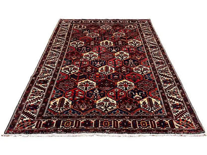 Rectangular Persian rug with an orderly pattern, dark red, blue, cream
