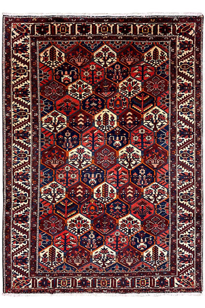 Persian rug with a symmetrical central motif and borders, dark red, blue, beige