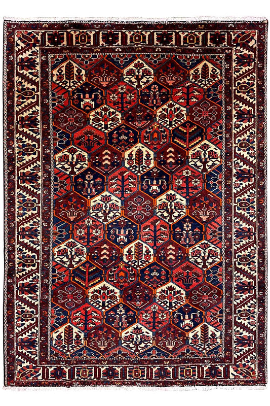 Persian rug with a symmetrical central motif and borders, dark red, blue, beige
