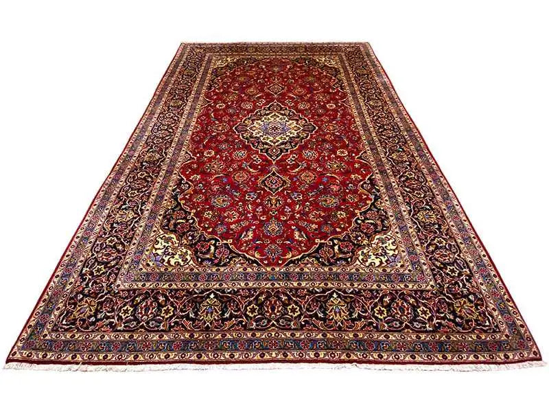 Red Keshan rug with a large medallion and dark ornamental border