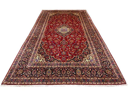 Red Keshan rug with a large medallion and dark ornamental border