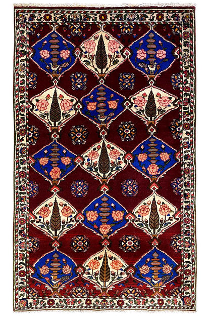 Bakhtiari rug (186x102 cm) with a geometric diamond pattern, burgundy background, and border.