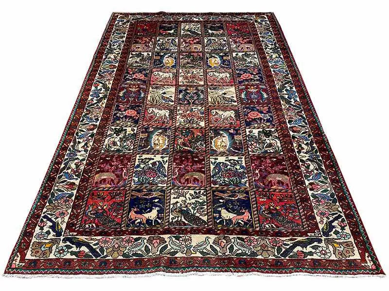 Flat Oriental rug with a dark field, light border, and patchwork motifs