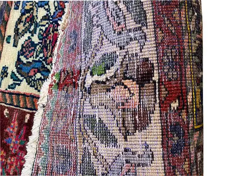 Detailed view with a white decorative medallion and colorful patchwork-pattern borders