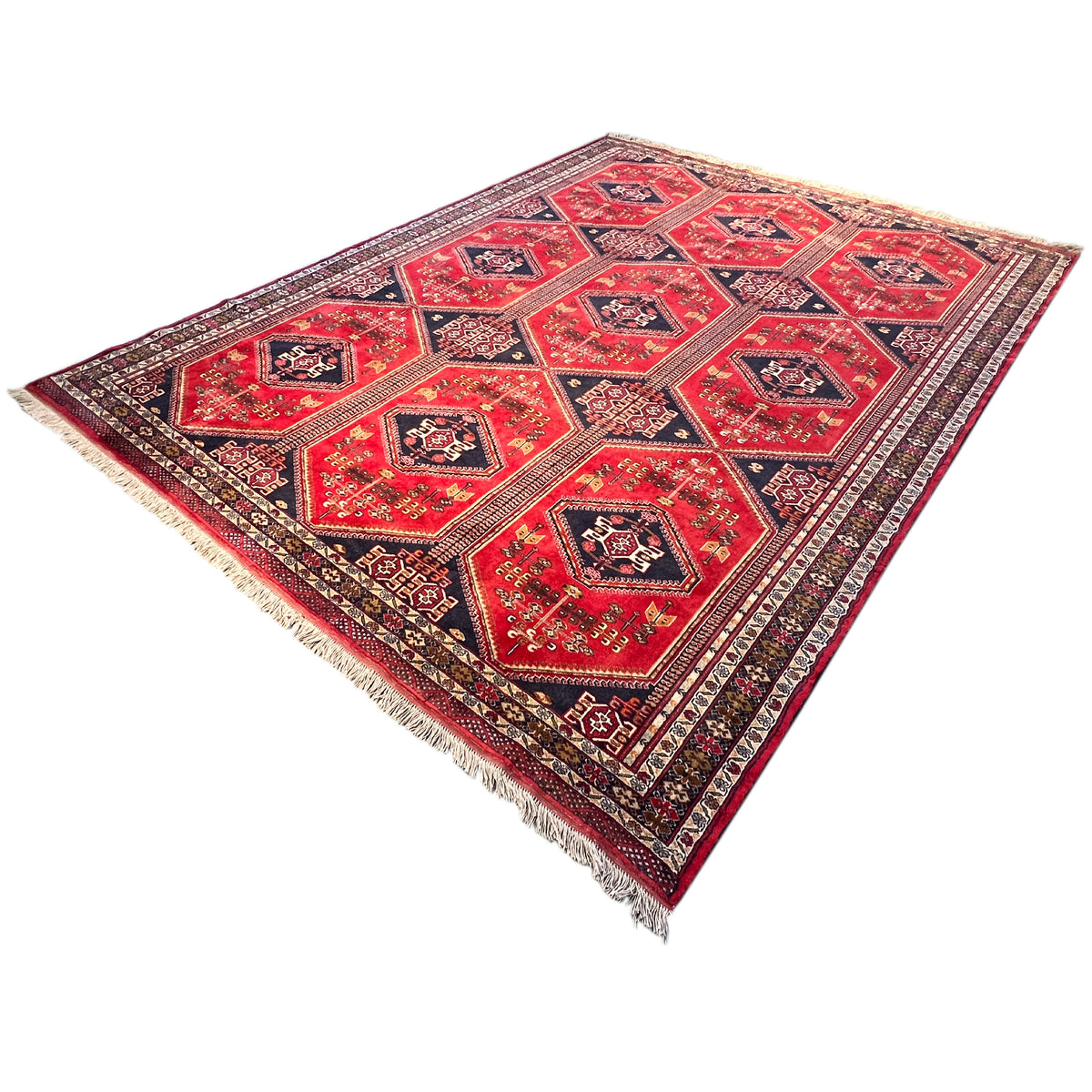 Baluch rug with a red medallion pattern and dark blue border, with fringes