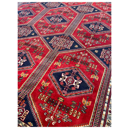 Baluch rug detail: red medallion pattern with small ornamental inserts