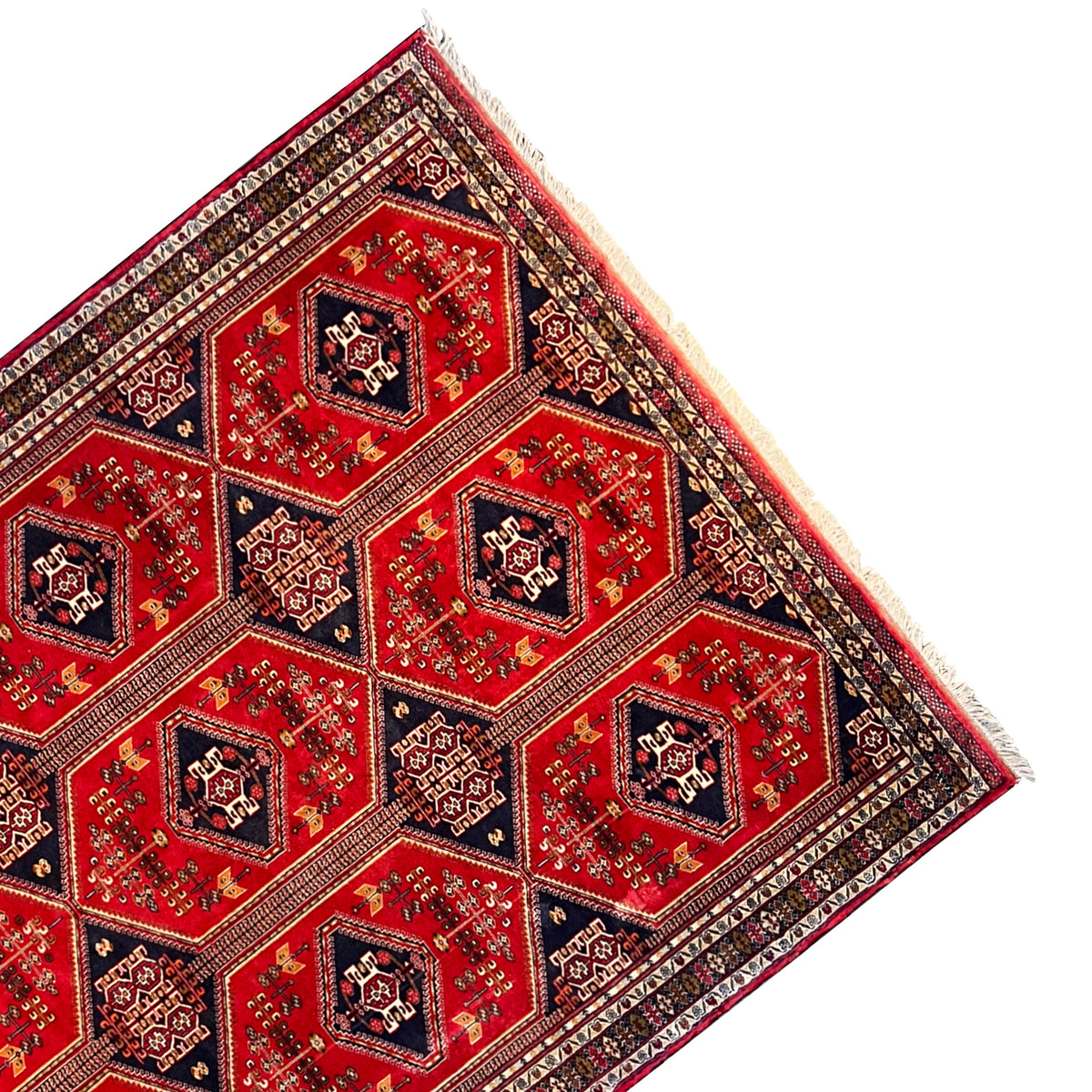 Baluch rug corner with a red medallion grid and multilayered border structure