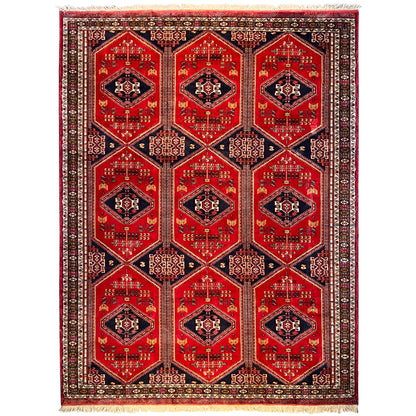 Baluch rug with a red ground, symmetrical medallion pattern, and dark blue accents