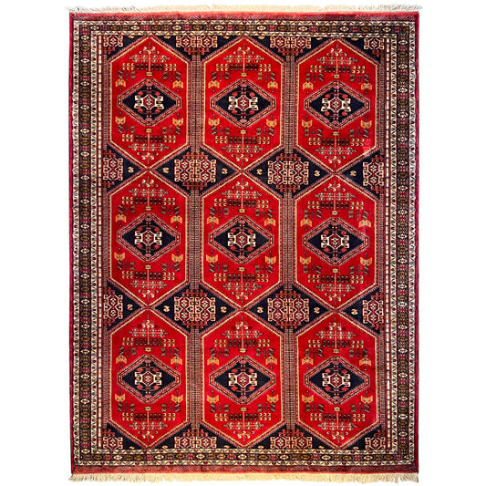 Baluch rug with a red ground, symmetrical medallion pattern, and dark blue accents