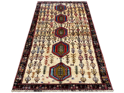 Baluch rug, cream with dark borders and tiered hexagons, approx. 176x99 cm
