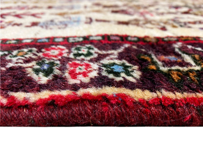 Close-up of a Baluch rug: thick pile with red and multicolored patterns along the edge
