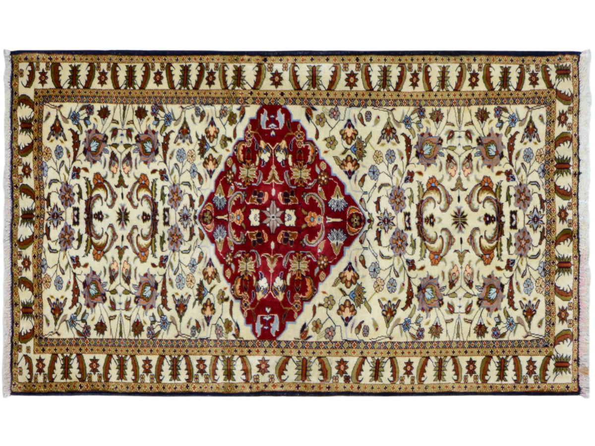 Baluch rug with wide borders, red medallion on a cream-colored ground