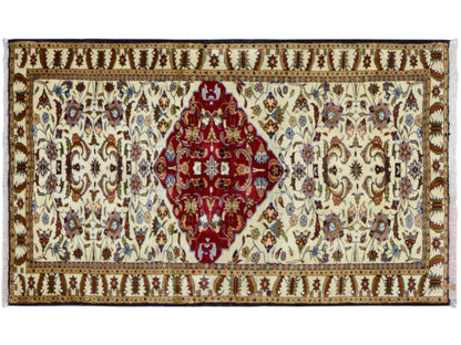 Baluch rug with wide borders, red medallion on a cream-colored ground