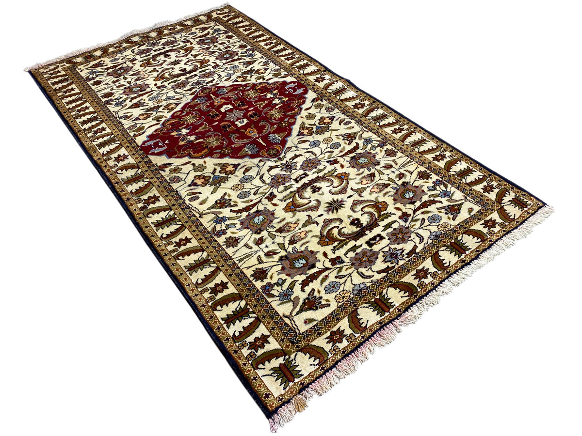 Baluchi rug with fringes, cream-colored ornamental pattern and red center