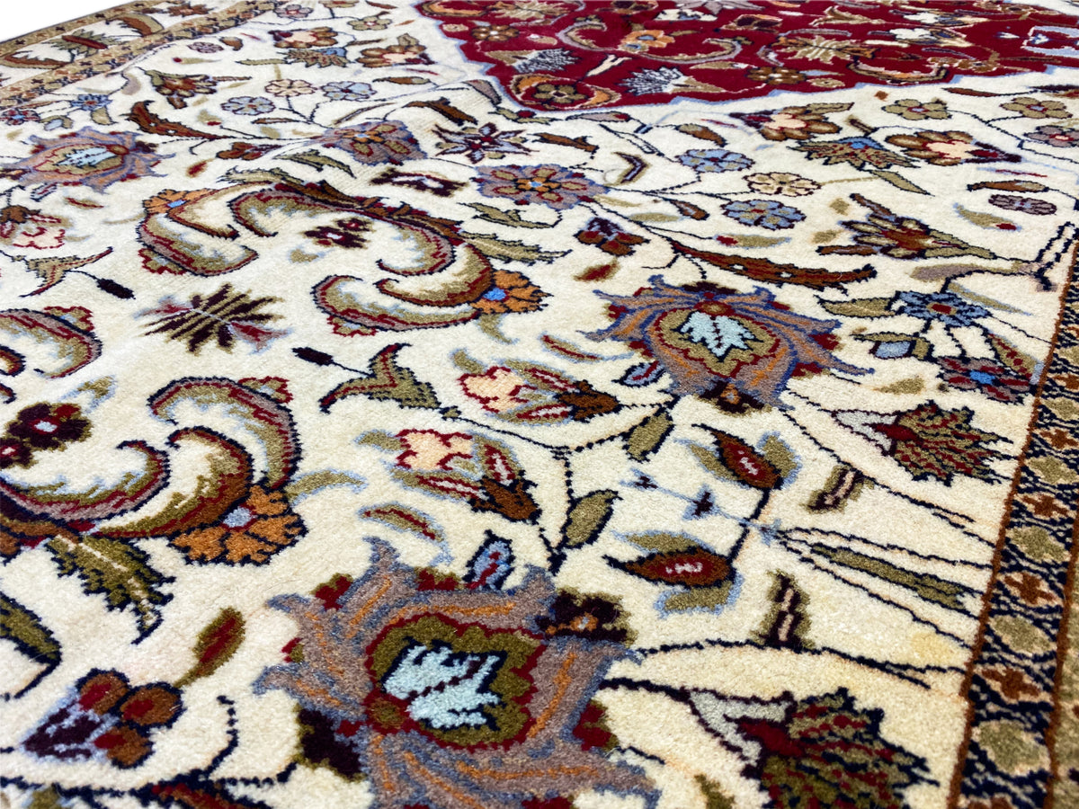 Baluchi carpet close-up: colorful ornaments on a cream-colored background