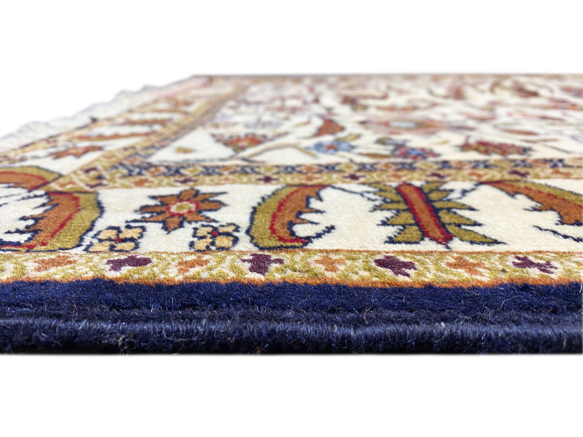 Baluchi rug corner with fringe, cream-colored pile and dark blue lower edge