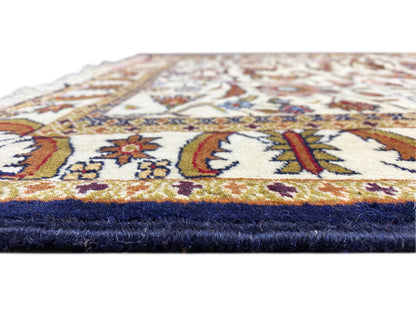 Baluchi rug corner with fringe, cream-colored pile and dark blue lower edge