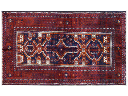 Rectangular Baluchi rug, red and blue, with a central ornamental field and an encircling border.