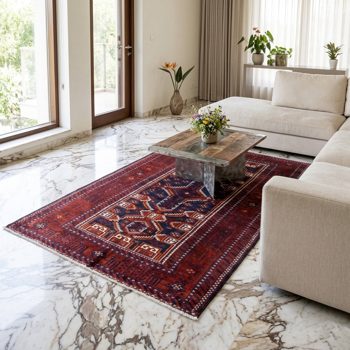 Rectangular Baluchi rug on a light-colored floor, red-and-blue geometric pattern with a border.