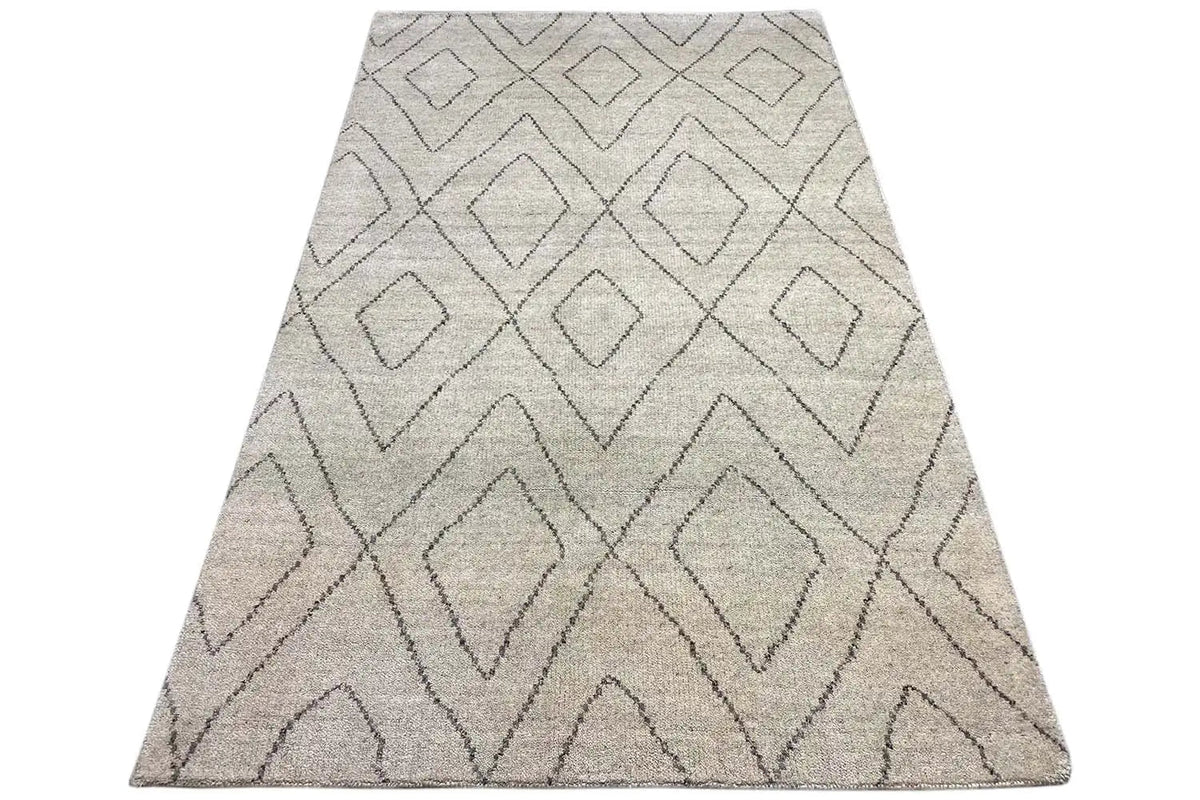 Berber rug in light beige with gray diamond and zigzag patterns, slanted