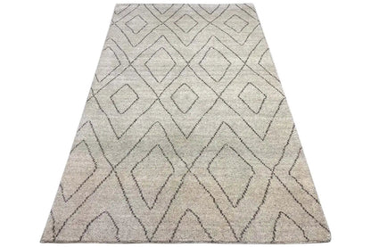 Berber rug in light beige with gray diamond and zigzag patterns, slanted