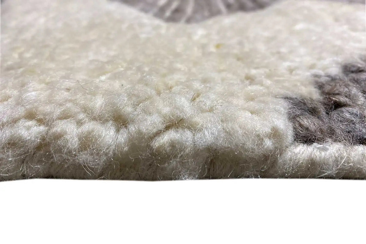 Berber rug close-up: short pile, mottled gray-beige pile texture